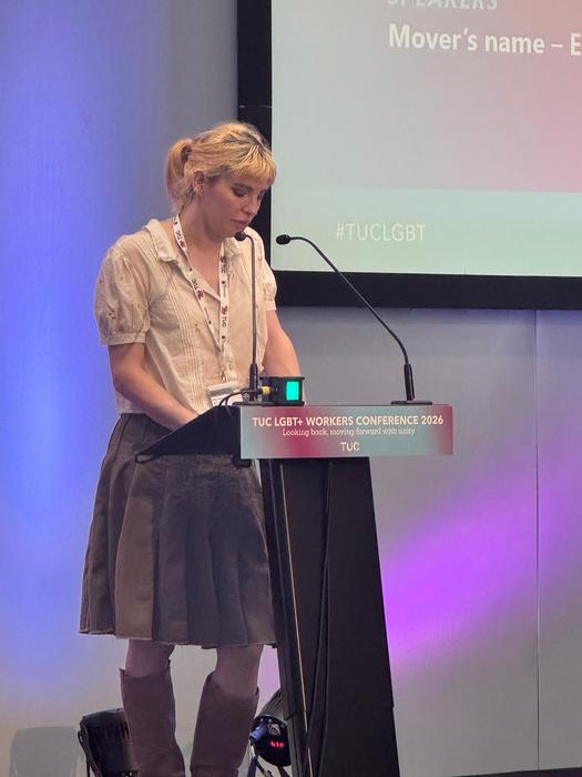 Holly Murtha standing behind a lectern and microphone.
