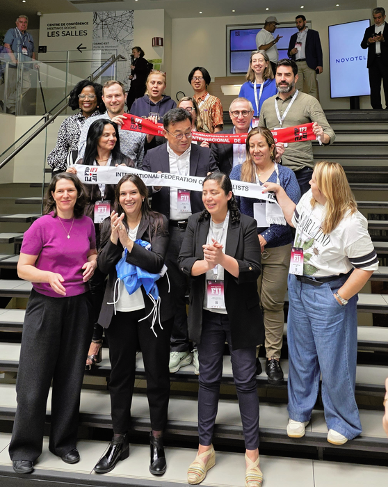 IFJ Executive Council members standing in rows on stairs.