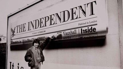 Brian Harris points to a billboard displaying the frontpage of The Independent.