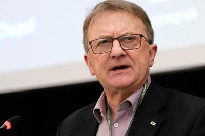Chris Morley wearing a suit and glasses speaks at DM 2025.
