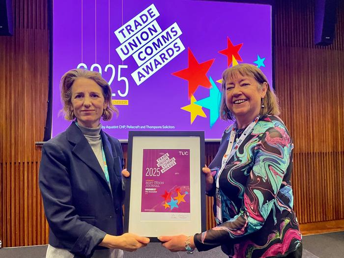 Kate Bell (left) and Christine Buckley (right) hold a plaque in front of a purple 'Trade Union Comms Awards' banner.
