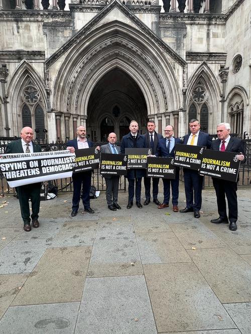 Barry and Trevor are joined by Seamus Dooley and others as they hold signs reading 'Journalism is not a crime' spying on journalists threatens democracy, outside the Royal Courts of Justice.
