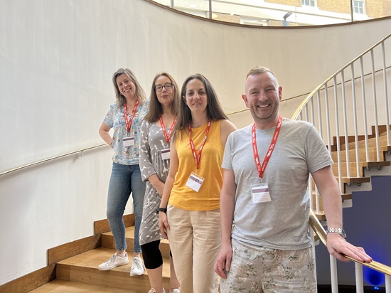 Delgegates standing on the stairs at conference: James Doherty, Natasha Hirst, Ann Galpin &  Cristina Lago
