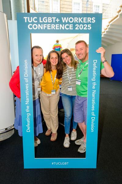 The NUJ delegation pose in a blue frame with the words 'TUC LGBT+ Conference 2025: Defeating the Narratives of Division'