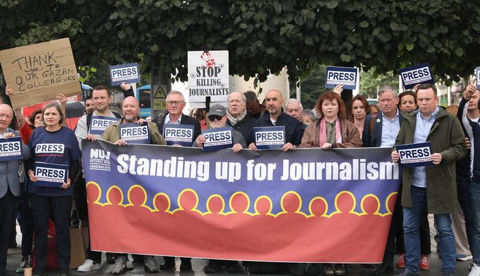 Group of NUJ members holding banner that reads, 'standing up for journalists'