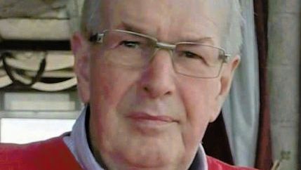 Paddy Clancy wearing glasses and a red jumper.