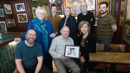 NUJ Belfast and District branch members unveil a photo of their colleague Lyra McKee at The Reporter bar in Belfast.
