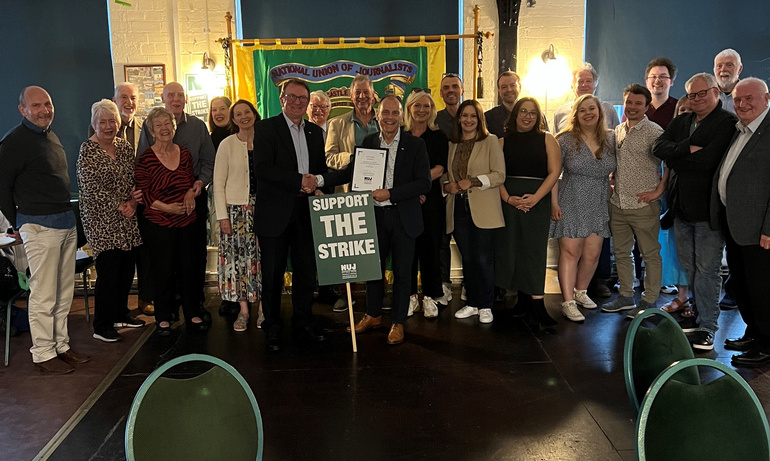 Attendees at Jeff Brown's life membership event pose for a photo.