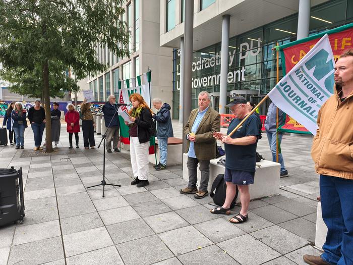 NUJ members standing outside UK government building in vigil for Palestinian journalists